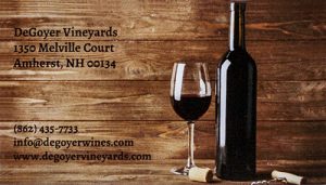 Wood-grain business card with a bottle or wine, glass, and cork, advertising for a winery.