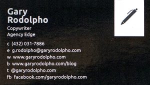 Black business card with a small pen icon in the upper right-hand corner, advertising for a copywriter.