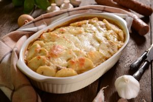 Potato gratin in a white baking dish.