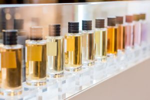 set of colorful perfume bottles in shop window.