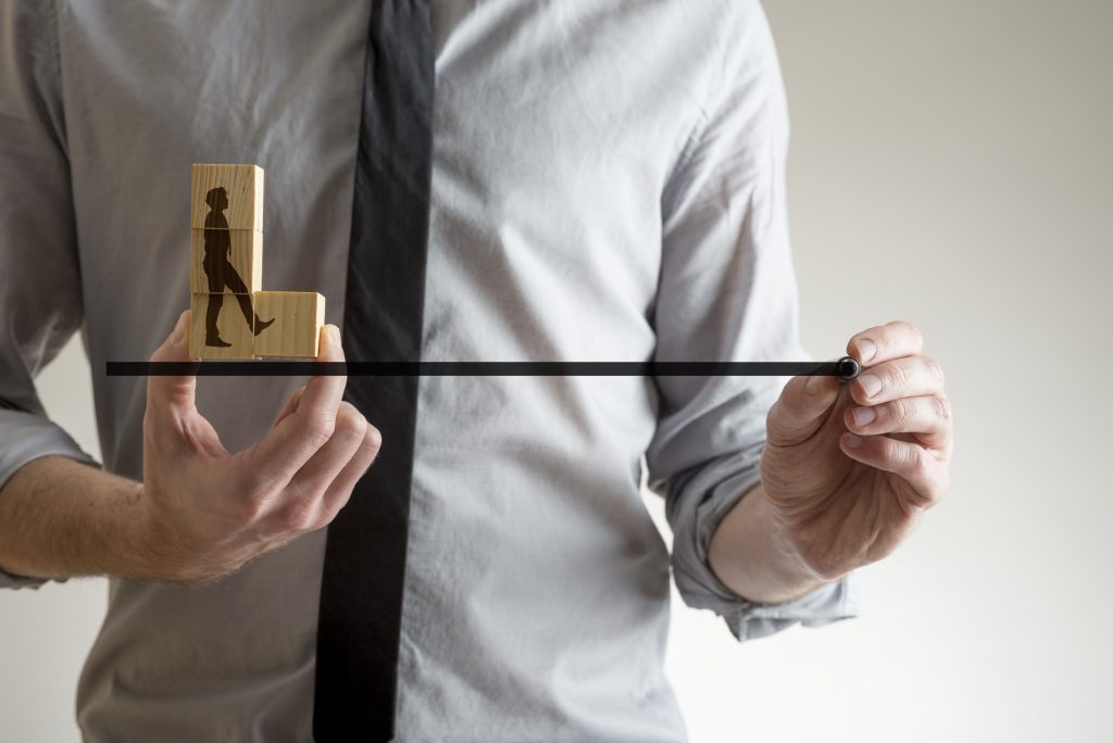 Man drawing the line with a marker pen for the silhouette of a businessman, conceptual of partnership and teamwork.