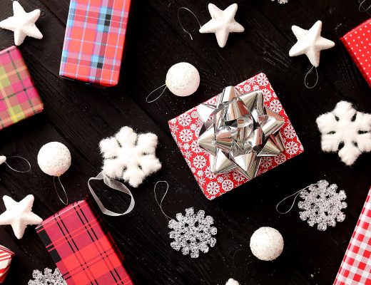 From above view of colorful wrapped presents and Christmas decorations laid on wooden background