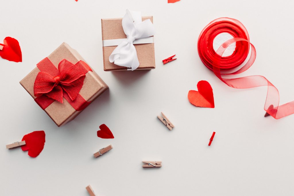 Gift with red ribbon and hearts