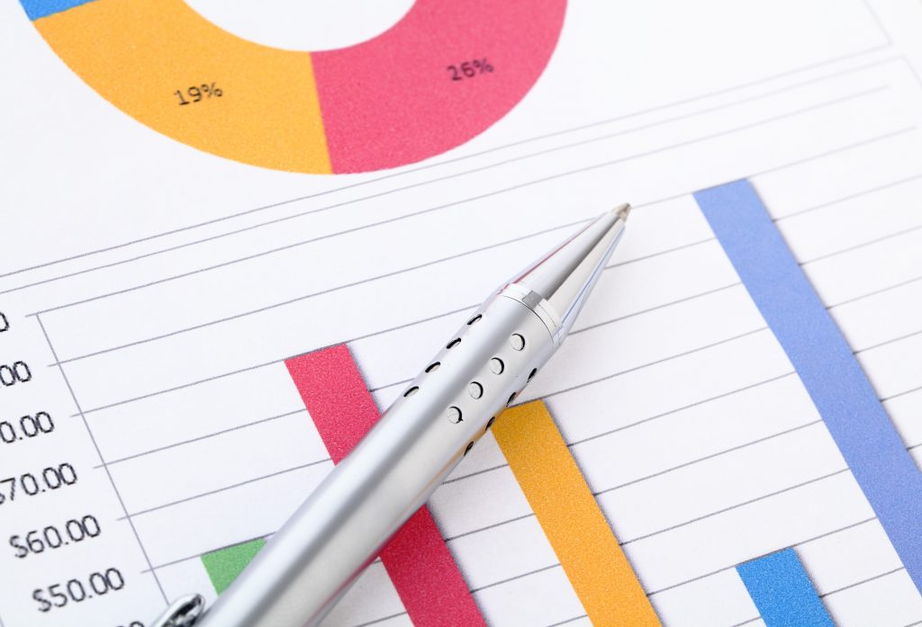 Colorful chart analysis with silver pen on white paper.