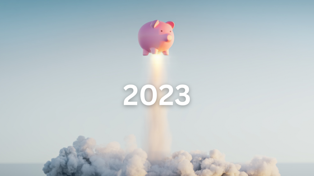 A piggy bank flying in the sky with the year 2023 displayed.
