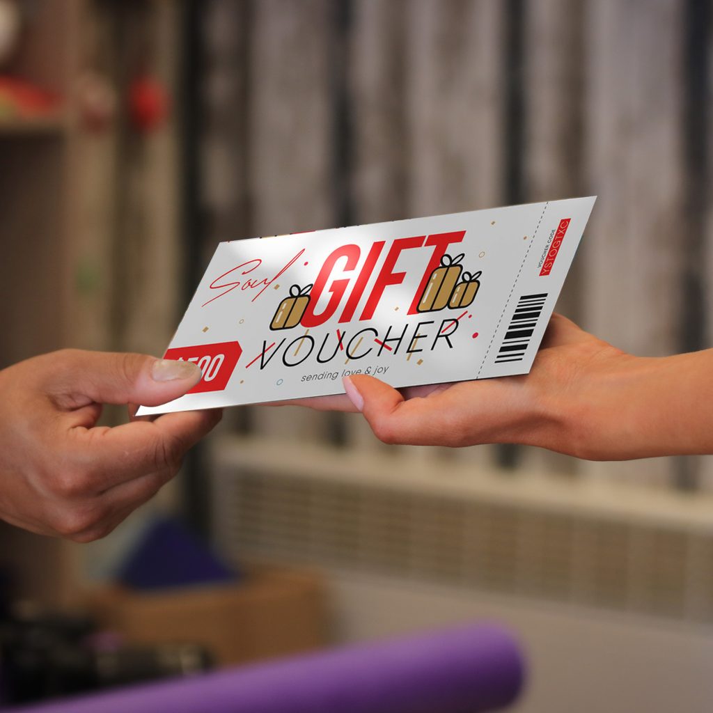 Someone handing another person a gift voucher.